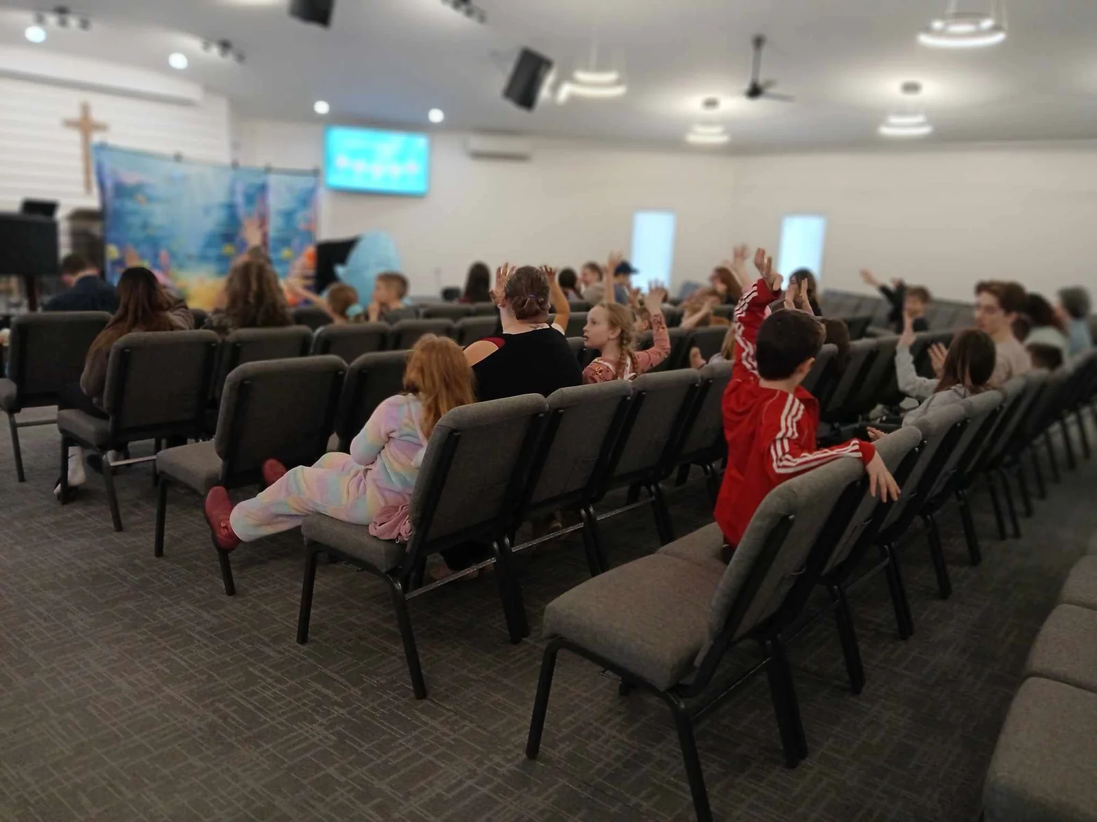 Children and teens seated together during a Calvary Next Gen gathering